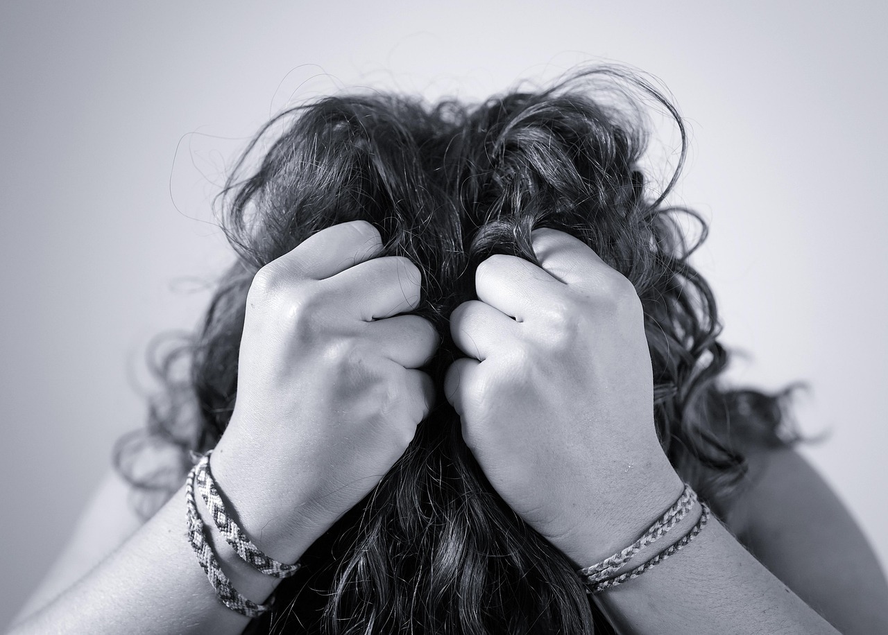 Person showing signs of stress, symbolizing the emotional toll of burnout while working from home